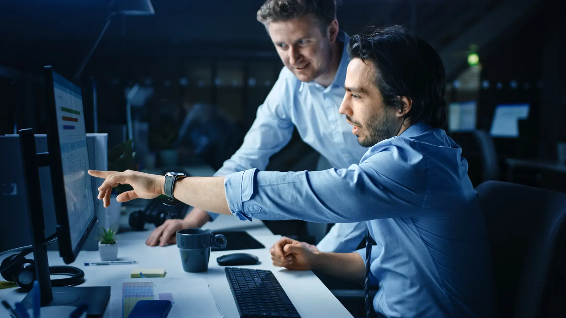 two IT persons reviewing vulnerabilities on the computer screen
